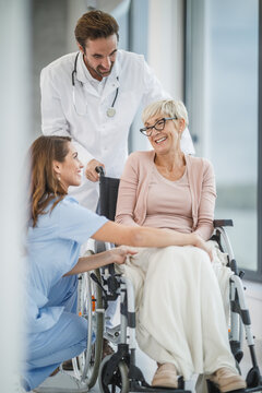 Doctor, nurse & caretaker visiting patient at home